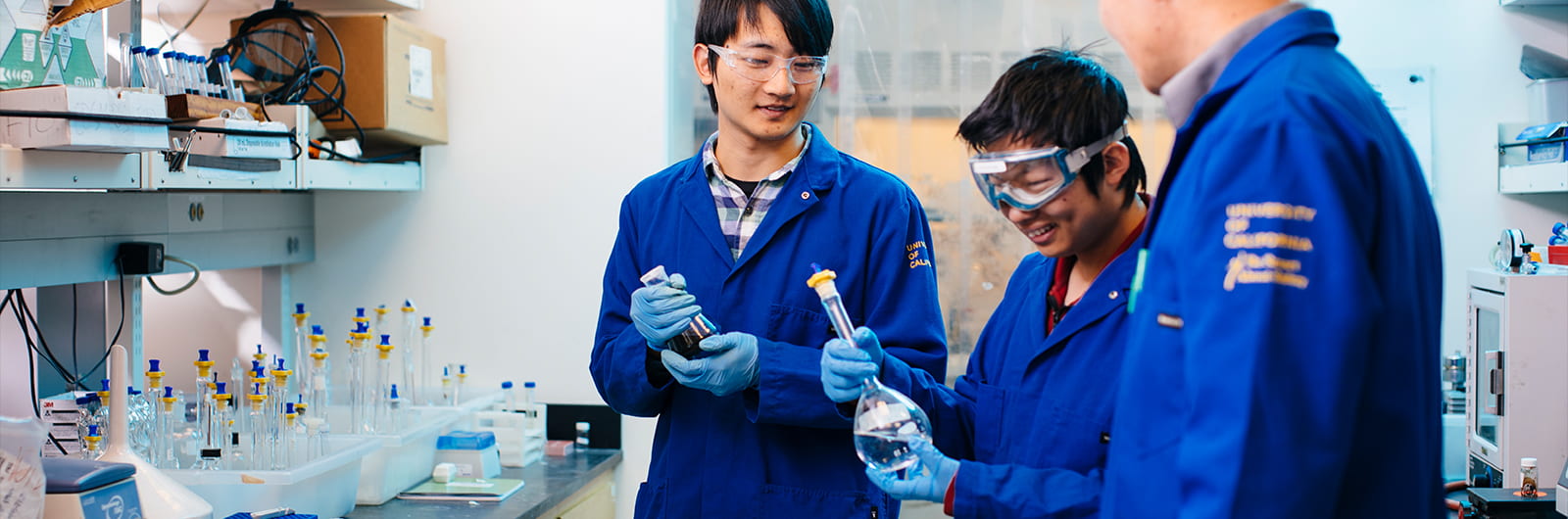 Chemist Shaowei Chen talks to students in lab, UCSC Science, photo credit Elena Zhukova 2019