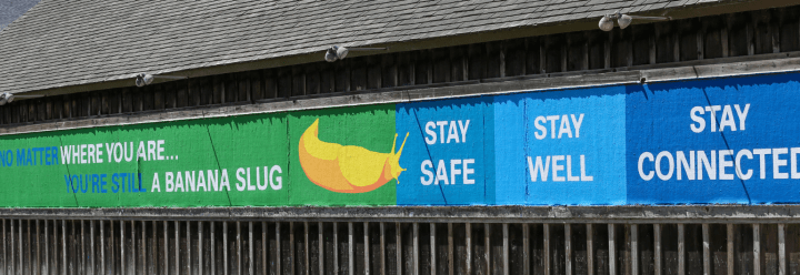 A sign reads "Where ever you are, you are a banana slug. Stay safe, stay well, stay connected."