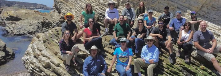 student and faculty researchers on a coastal cliff