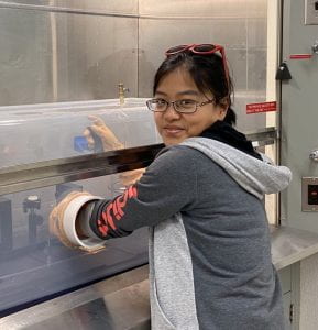 Dr. Xinting Yu in the lab with her homemade equipment.